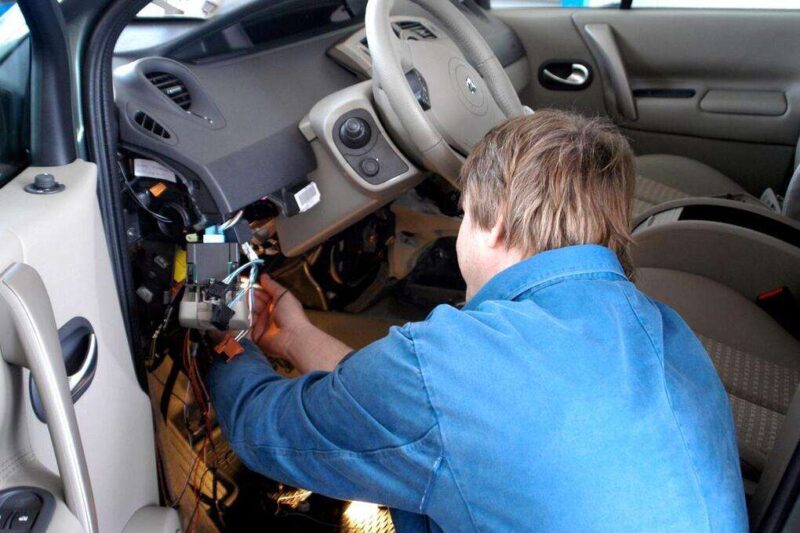 1200 2469041 man disconnecting wires of car