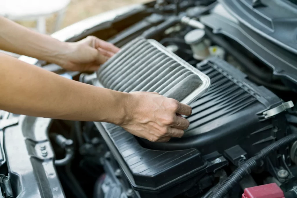 technician holding air filter