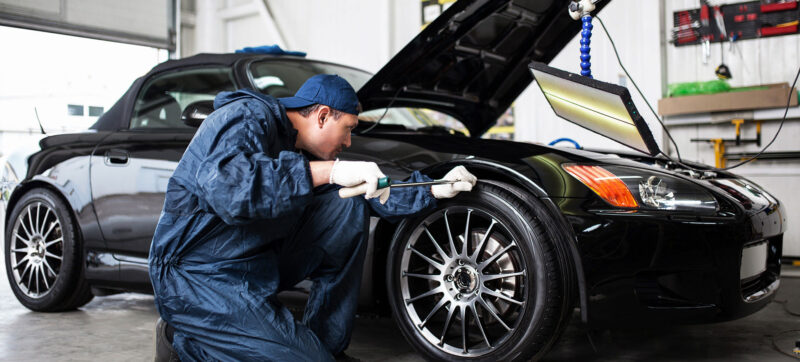 Car Serviced by Mechanic in Auto Body Shop