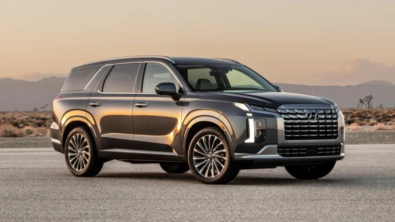 Front angle view of dark gray 2023 Hyundai Palisade highlighting its release date and price